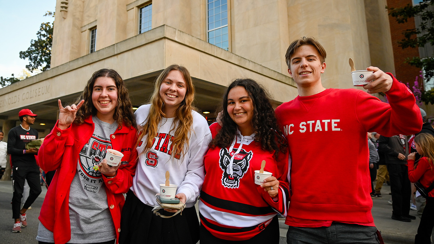 Wolfpack fans hold up wolfies — and Howling Cow ice cream — outside of Reynolds Coliseum.