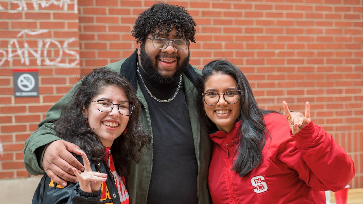 Members of the Latinx Alumni Network hold up their wolfies.