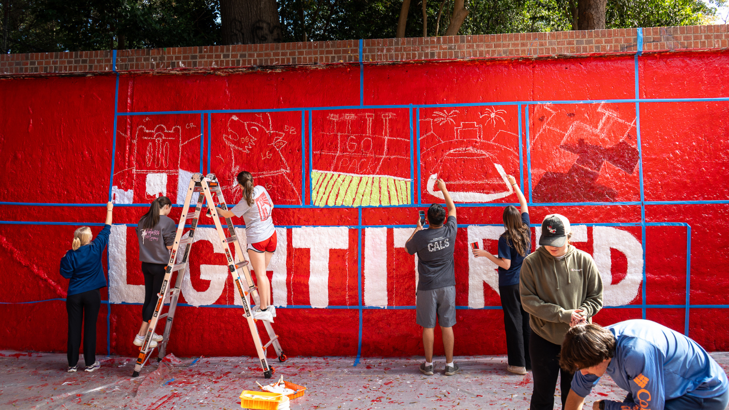 painting Light it Red mural in Free Expression Tunnel